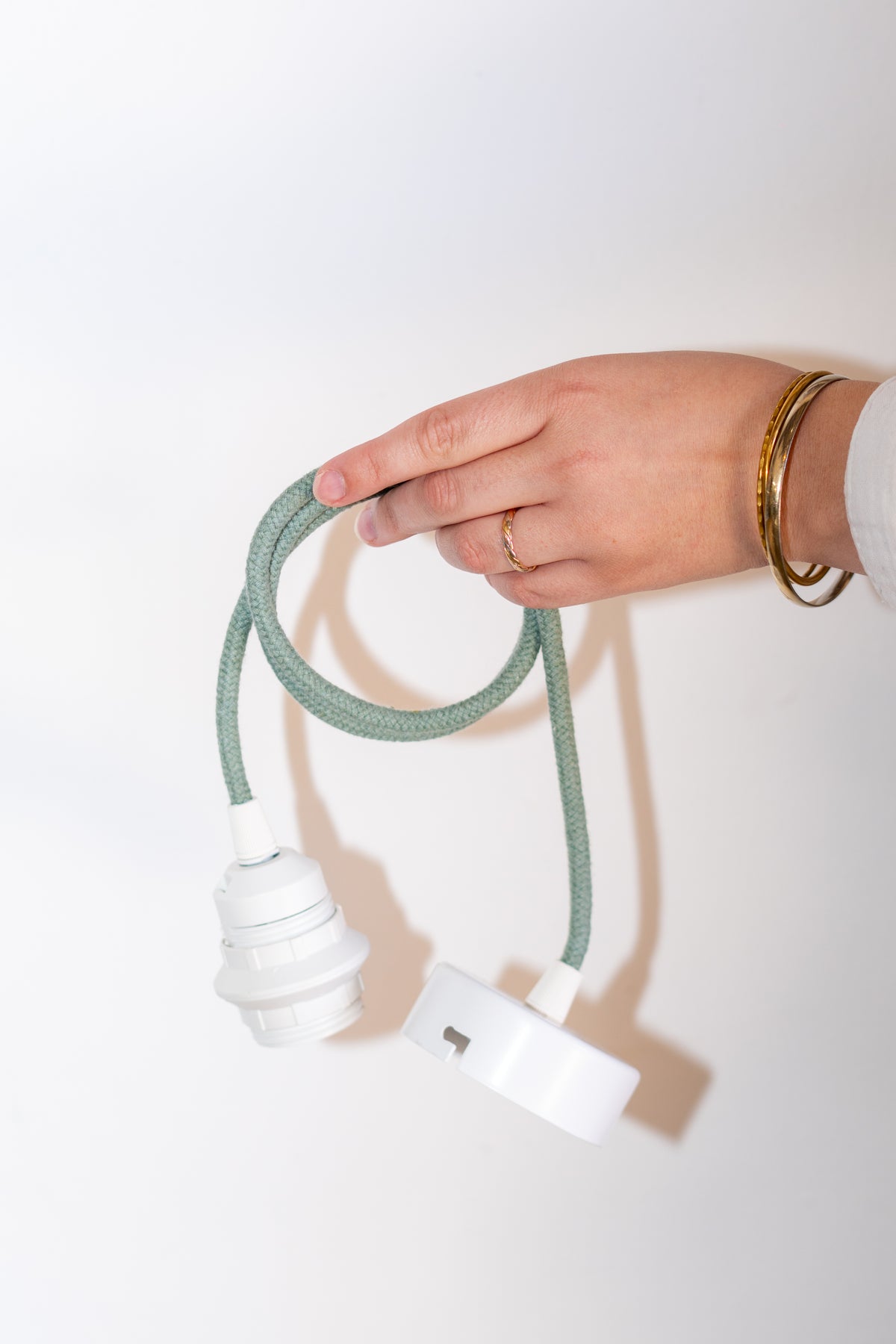 Textured sage green pendant lamp cord with white fittings